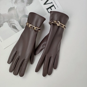 Women's dark brown PU leather gloves with a chunky gold metal chain on a white background