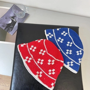 Handcrafted crochet bucket hats in red and blue featuring geometric H patterns