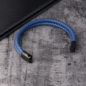 Close-up of blue braided leather bracelet for men with black matte metal magnetic clasp