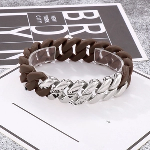 Close-up of mixed silver metal and brown silicone Cuban link bracelet on display