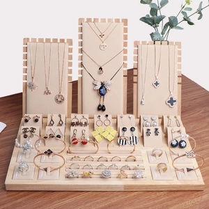 Natural wood jewelry display set with beige velvet lining for necklaces and rings