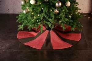 Detail of red and black striped knitted Christmas tree skirt with woven texture