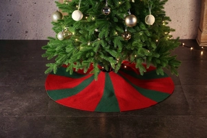 Close-up of red and green knitted Christmas tree skirt with thick wool texture