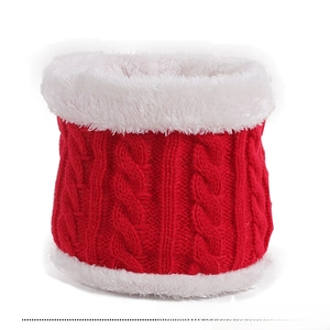 Detail of red cable-knit children's neck warmer with thick white faux fur lining