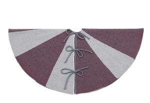 Detailed view of gray and red knitted Christmas tree skirt with textured pattern ties
