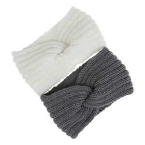Close-up of white and dark grey knitted twist headbands with soft wool texture