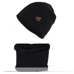 Close-up of black winter knitted hat and neck warmer set with thick fleece lining