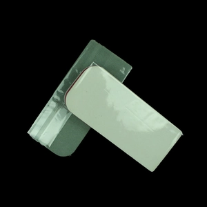Detail of green abrasive surface and white polished nail buffer block for manicure