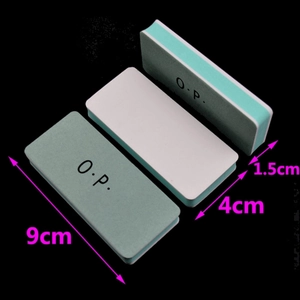 Macro view showing 9x4x1.5cm green and white dual-sided nail buffer blocks