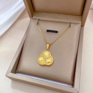 Titanium steel gold necklace with three spinning concentric sunburst circles on a box chain