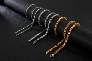 Detail of gold and silver stainless steel braided chains with lobster clasps