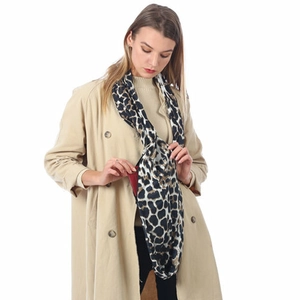 Detail of leopard print infinity scarf with zipper pocket on a beige trench coat