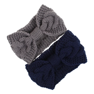 Detail of twisted cable knit headbands in dark grey and navy blue with bow knot design