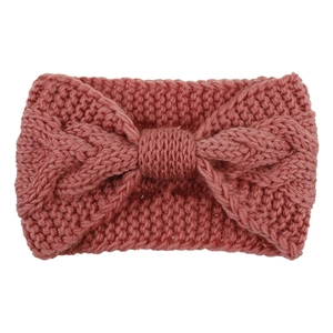 Detail of cable knit headband in dusty rose featuring a textured bow knot design