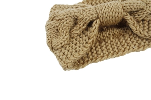 Close-up of ginger yellow cable knit headband featuring soft texture and front bow detail