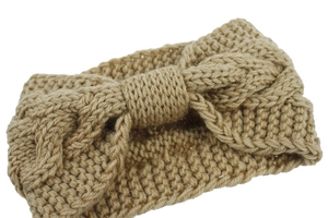 Close-up of light coffee cable knit headband featuring a large bow and thick texture