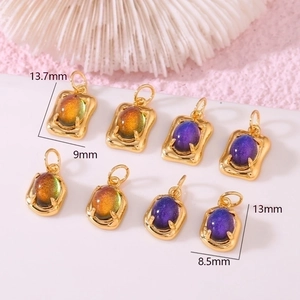 Detail view of 14K gold plated oval pendants with candy-colored stones and dimensions