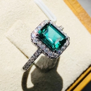 Classic silver ring with a green rectangular gemstone and sparkling small diamonds