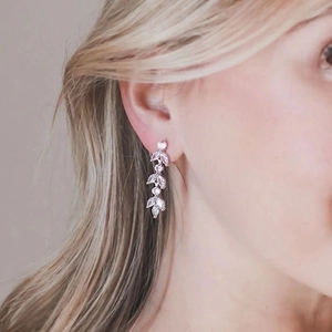 Silver leaf tassel earrings with sparkling zircon stones worn by a model in a high-quality view