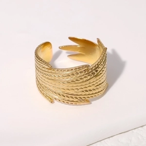 Detailed close-up of a golden adjustable feather ring with intricate engraved textures