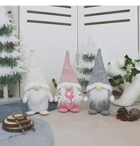 Close-up of Nordic faceless gnomes in white, pink, and grey with sequins and wood buttons