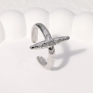Minimalist silver stainless steel open ring with hammered texture finish on white surface