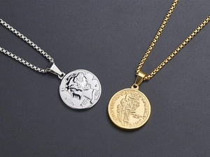 Macro detail of gold and silver coin pendants with embossed Roman portrait and Box chains