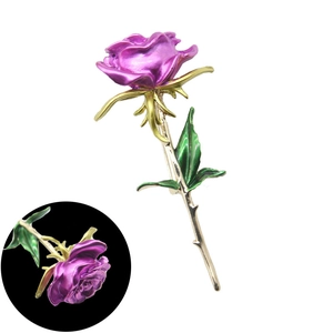 Detail of a purple rose brooch with golden metal leaves and stem in baroque style