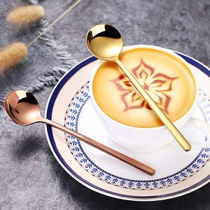 Elegant gold and rose gold 304 stainless steel coffee spoons set on a latte cup saucer