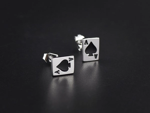 Detail of ace of spades stud earrings in silver stainless steel on black background