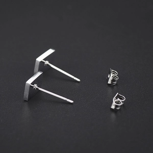 Sleek silver stainless steel square stud earrings for men and women on black background