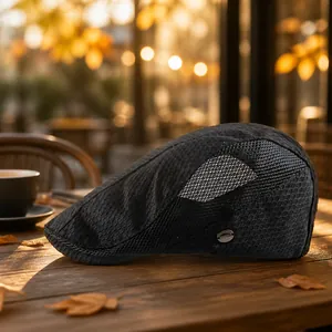 Breathable black mesh ivy cap with honeycomb texture and metal brand tag detail