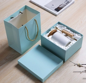 Detailed gift set featuring a white ceramic mug with wooden handle and matching blue box