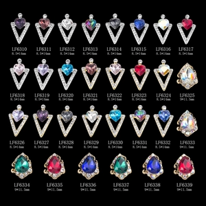 Detailed view of 3D alloy nail art charms with vibrant gems and sparkling rhinestones