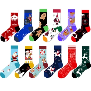 Flat lay of twelve assorted Christmas crew socks with colorful festive holiday patterns