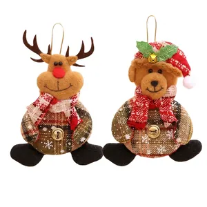Detail of plush Christmas elk and bear ornaments with bells and plaid fabric