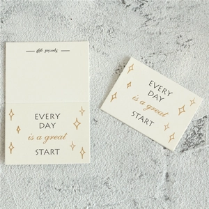 Close-up of minimalist beige greeting card with inspirational quote on stone background
