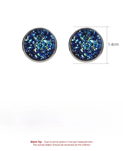 Macro detail of round stainless steel studs with teal galaxy glitter stone inlay