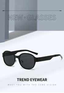 Detail of retro black round frame sunglasses featuring silver metal nose bridge accents