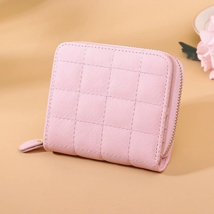 Close-up of pink quilted PU leather wallet with metallic zipper and elegant texture