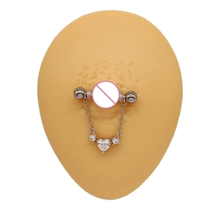 Detail of heart-shaped zircon pendant on stainless steel nipple ring bar with chain