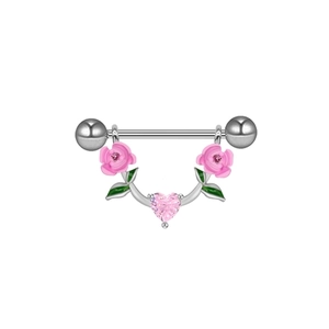 Macro shot of steel nipple bar with pink roses and a heart-shaped gemstone detail