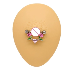 Detail of nipple piercing featuring pink enamel roses and heart-shaped zircon crystal