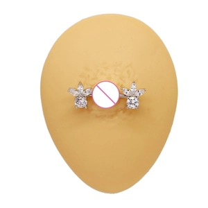 Detail view of flower-shaped stainless steel nipple ring with sparkling zircons on silicone model