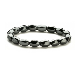 Macro view of polished oval hematite beads with metallic luster on elastic bracelet
