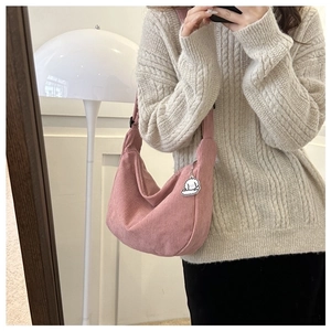 Pink corduroy crossbody bag with cloud charm detail shown in a stylish mirror selfie view