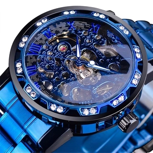 Macro shot of men's blue hollow mechanical watch with tourbillon-style gears and zircon bezel