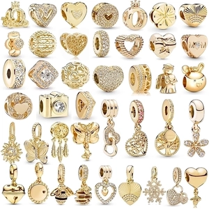 Golden beads and charms collection with heart flower and bee designs for DIY jewelry