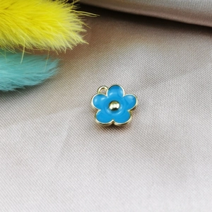 Macro view of light blue five-petal flower pendant with golden edges for DIY jewelry