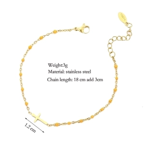 Minimalist gold stainless steel cross bracelet with yellow beads and extender chain